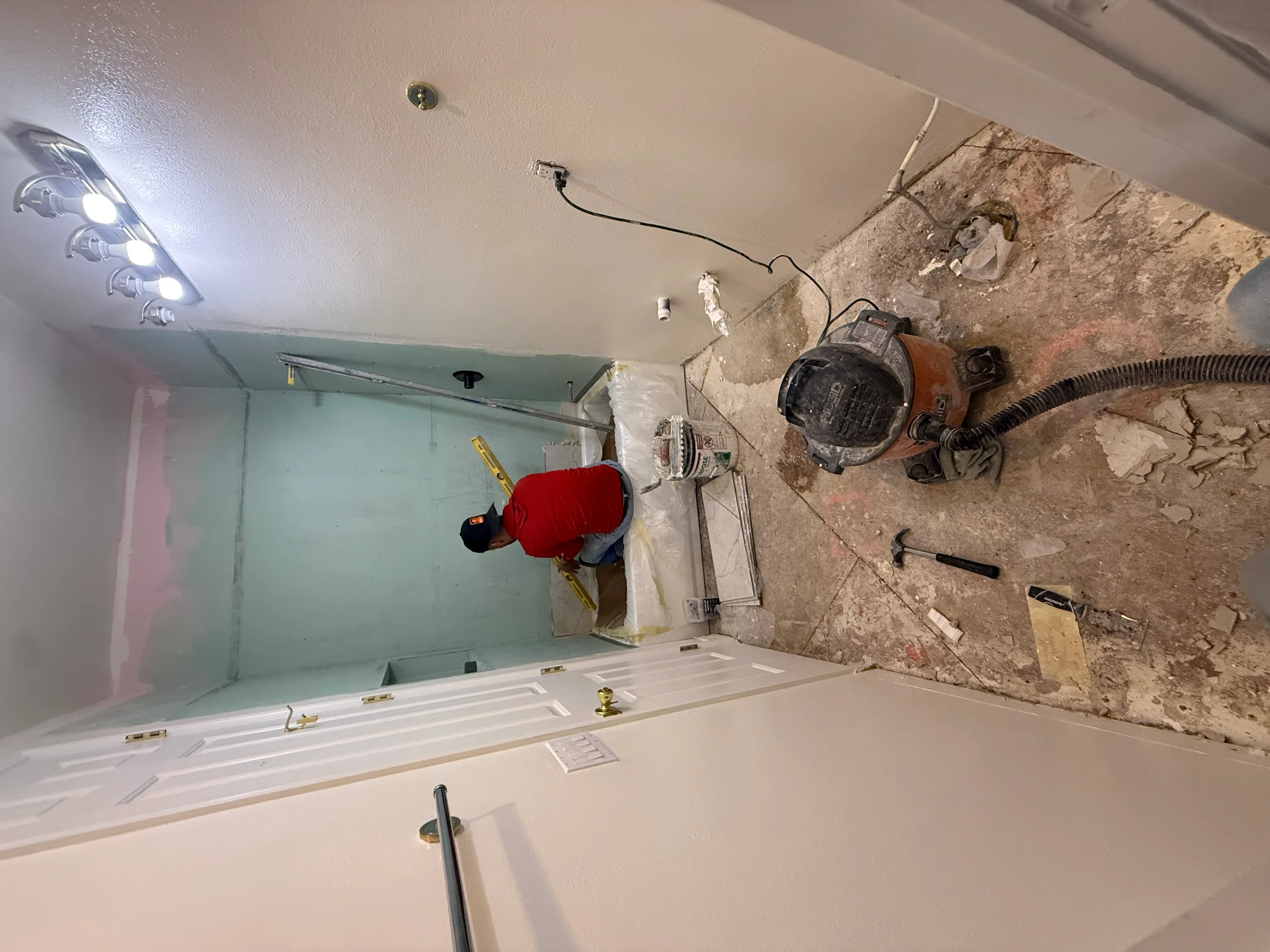 Bathroom under renovation with new drywall, recessed lighting, and electrical rough-in work